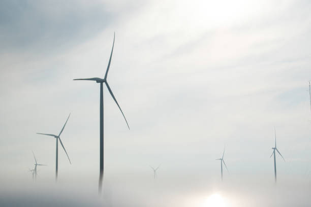 istock Windmills towers for producing energy hidden in thick smog 1483072922