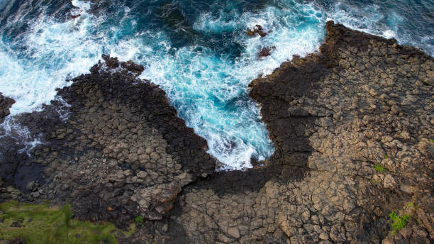 Australian Coastline Drone shots over pacific ocean with a view of rocks, waves, beach, lighthouse and blowhole in Kiama