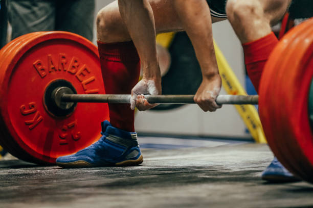 male powerlifter deadlift in powerlifting competition, hands in gym chalk, grips of barbell bar male powerlifter deadlift in powerlifting competition, hands in gym chalk, grips of barbell bar gripping bars stock pictures, royalty-free photos & images