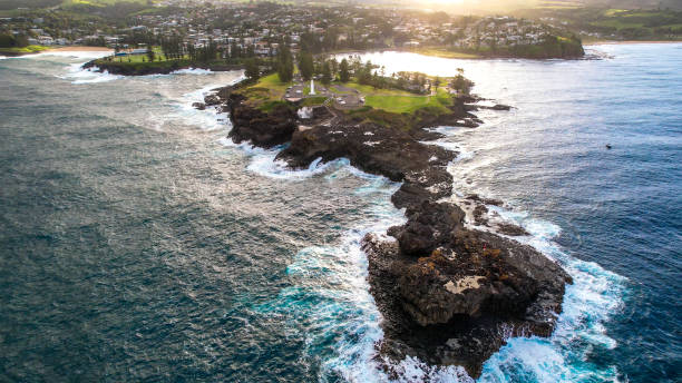 Australian Coastline Drone shots over pacific ocean with a view of rocks, waves, beach, lighthouse and blowhole in Kiama