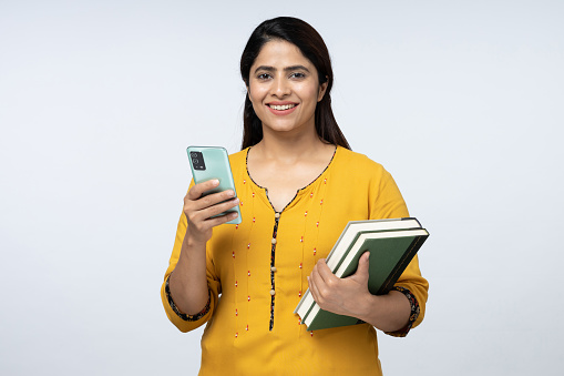 Portrait of adult student holding book on isolated white background