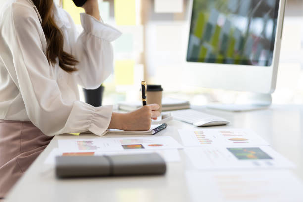 istock Businesswoman in the office working with project budget documents and analyzing financial charts. 1483074868