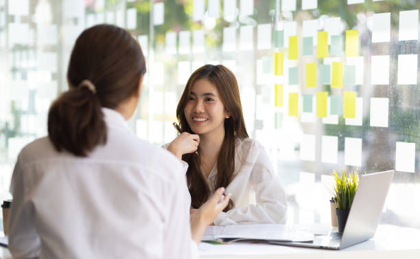 istock Two female colleagues discuss start-up projects and plan corporate strategy. Consultant new startup project idea presentation analyze plan marketing and investment in the office. 1483075018