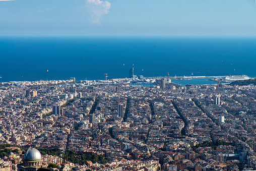 Aerial view from the Tibidabo hill of Barcelona city and the Mediterranean sea, Spain.