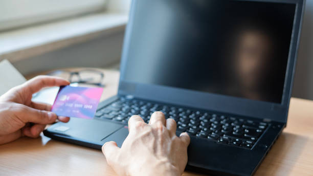 istock Close-up Man shopping on laptop using credit card 1483076979