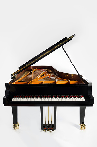 Luxury grand piano with open lid on white background