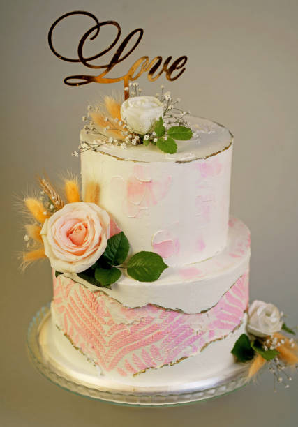 istock Festive wedding bunk cake decorated with fresh flowers on a dark background 1483079197