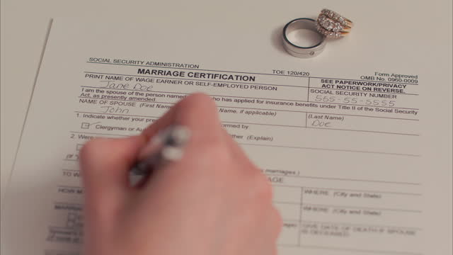 Caucasian Female Hand Filling Out Marriage Certificate