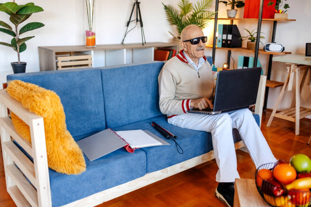 istock Active blind senior adult sitting on sofa in living room 1483084347