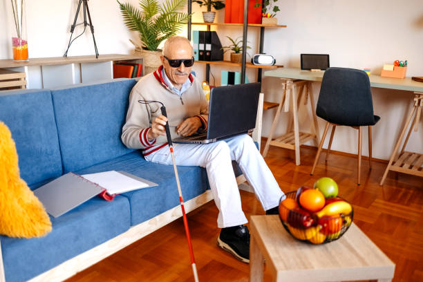 istock Active blind senior adult sitting on sofa in living room 1483084356