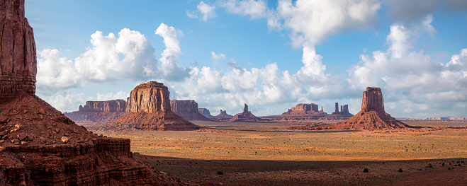 Panoramic view of The Mittens and Merrick Butte from North Window Overlook in Monument Valley tribal park at sunset. Arizona and Utah border, United States of America