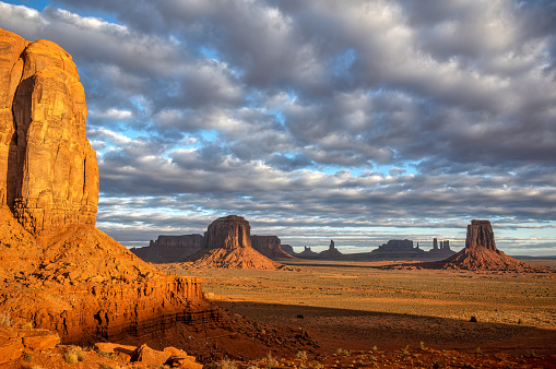 Panoramic view of The Mittens and Merrick Butte from North Window Overlook in Monument Valley tribal park in the morning. Arizona and Utah border, United States of America