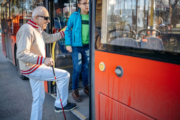 istock Active blind person gets on the bus with child support 1483084763