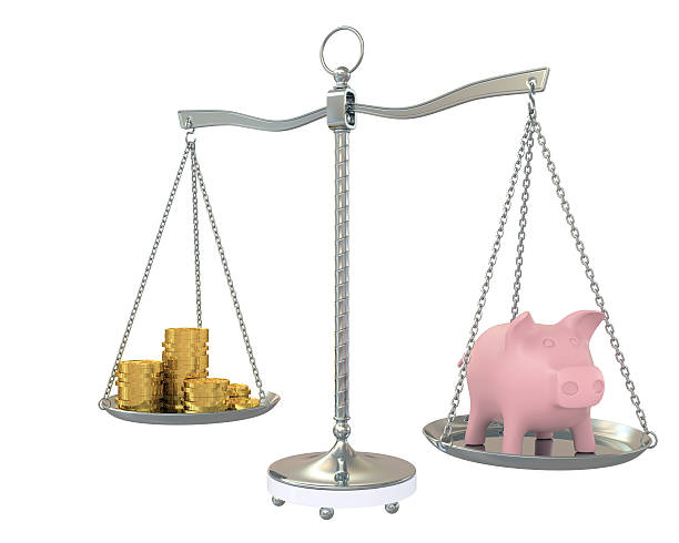 istock Piggy and gold coins on the scale 148308484
