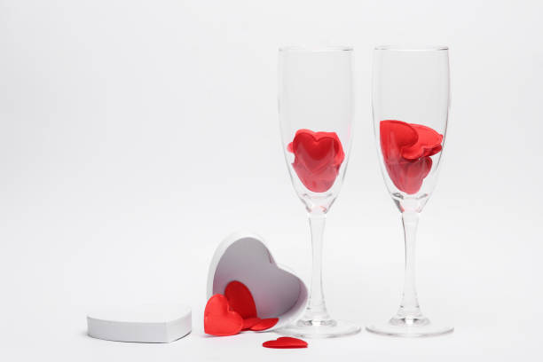 istock Two glasses with hearts and gift box on white background. Valentine's Day, February 14 1483086008
