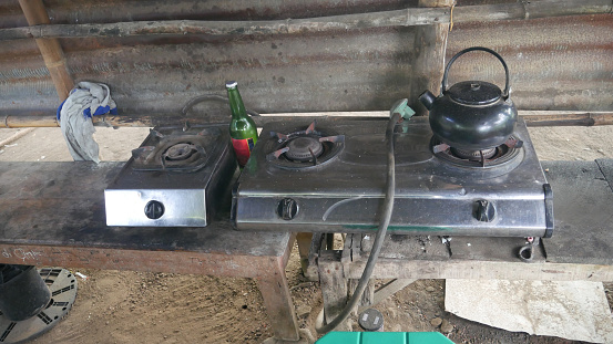 Gas Stove on wood Table and an Empty Bottle At The Side, Kediri, East Java, Indonesia, October 9, 2022