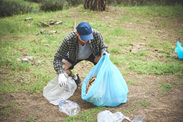 istock young adult cleans the forest from debris 1483090407