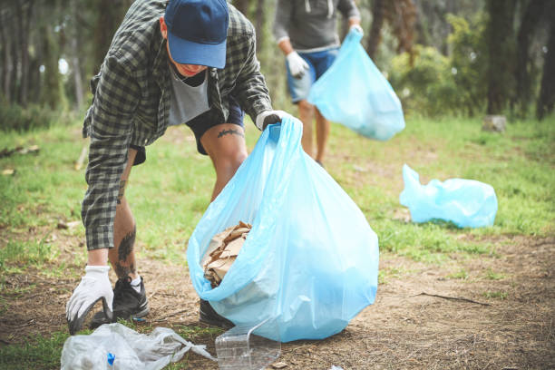 istock father and son clean up trash in the forest 1483091328