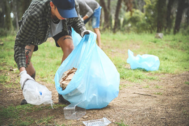 istock father and son clean up trash in the forest 1483091996