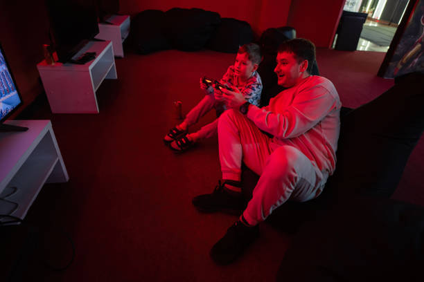 istock Father and son play gamepad video game 1483093910