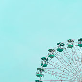 istock Reliving Nostalgia - An 80's Ferris Wheel in a Bright Blue Sky 1483093935