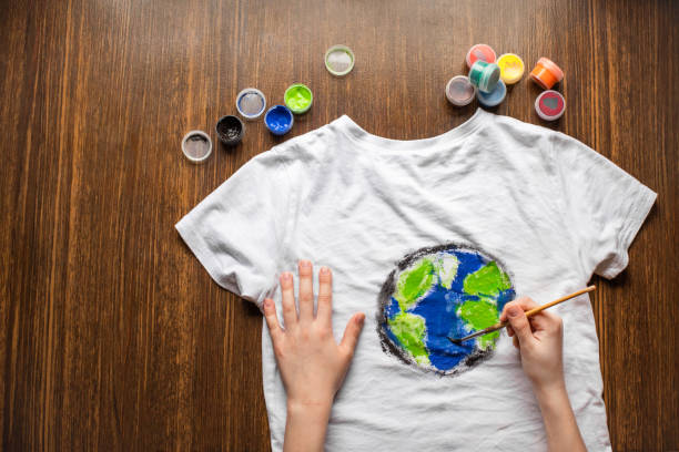 Drawing earth globe on t-shirt. Top view