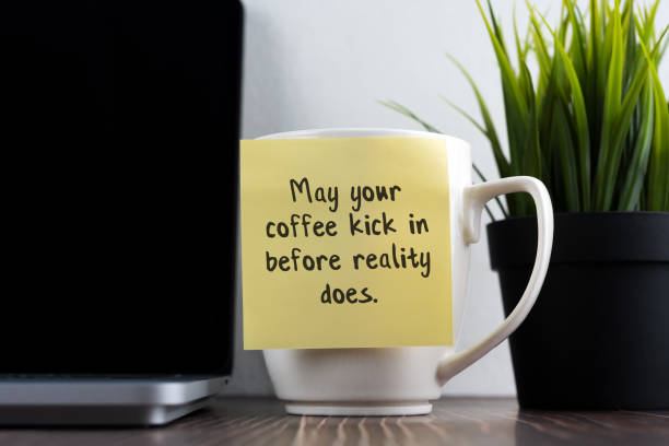 istock Sticky note of coffee mug with text - May your coffee kick in before reality does 1483099261