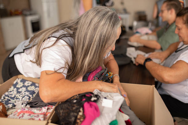 istock Woman sorting a pile of clothes in a box 1483099306