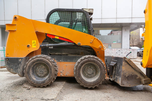 istock Not a big yellow mini loader with a bucket in front to level the ground. Wheeled bulldozer. 1483100204