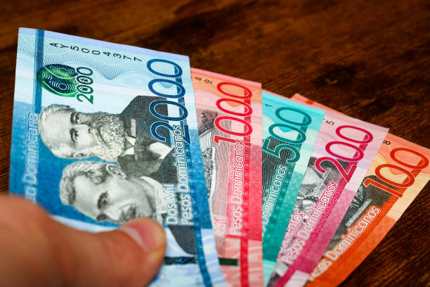istock Dominican Republic money, Pesos banknotes held in hand 1483100496