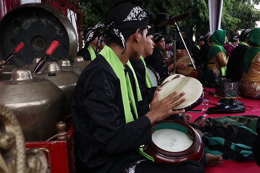 Group of gamelan players playing traditional Javanese music. They wear traditional Javanese clothes. Gamelan players in Batang Indonesia, 8 April 8 2019