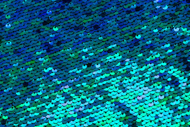 istock Sparkling sequined textile in mermaid color. Turquoise background 1483105383