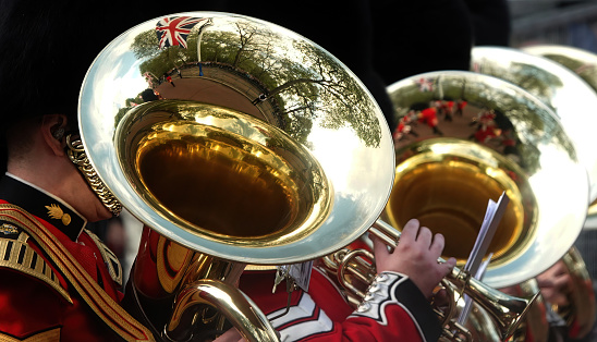 Trumpet line performing a halftime show. Focus on face visible in player facing left.