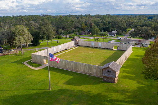 Ocala, Florida - USA, October 9, 2020 - Drone angle view of American flag and Fort King National Historic Landmark.