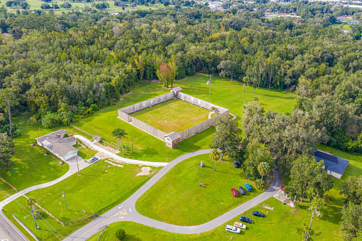 Ocala, Florida - USA, October 9, 2020 - Drone angle view of American flag and Fort King National Historic Landmark.