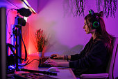 Teenage girl streaming playing video game on desktop PC