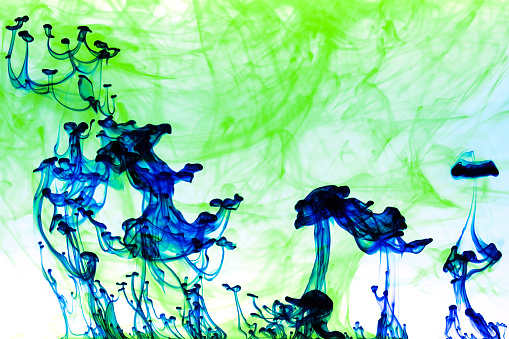 Bright paint immersed in water creating different abstract shapes