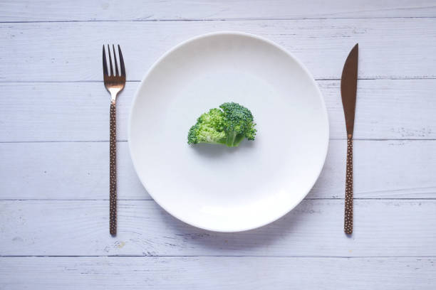 istock broccoli on a plate with cutlery on table 1483116189