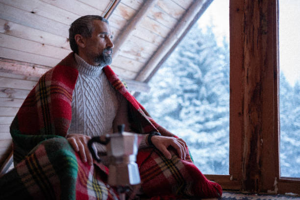 istock Cabin getaway. Man enjoys a log cabin retreat. 1483117150
