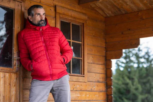 istock Cabin getaway. Man enjoys a log cabin retreat. 1483117190