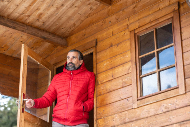 istock Cabin getaway. Man enjoys a log cabin retreat. 1483117193