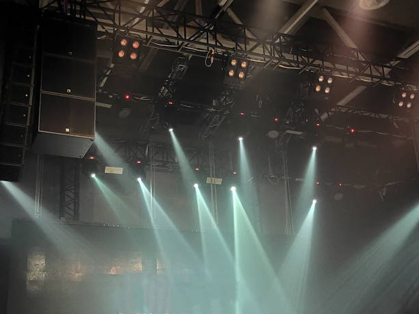 Professional lighting equipment on stage ceiling on blurred smoke background. Blurry sharpness. View from below