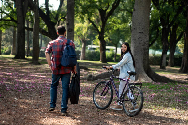 istock Friends talking while walking through the public park 1483118035