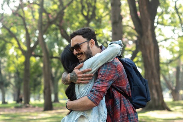 istock Friends embracing on the public park 1483118637
