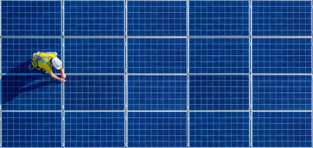 istock solar panel installer technician with yellow t-shirt and safety helmet with a big empty copy space 1483119470
