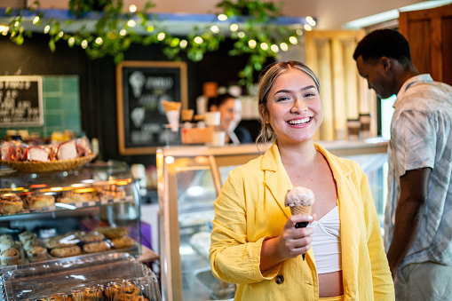 Portrait of young woman at the ice cream shop