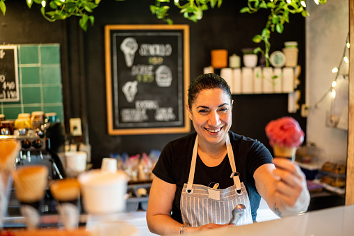 Portrait of mature ice cream vendor on the store