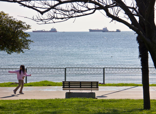 Istanbul, Turkey - April 8, 2023: People resting and walking near sea at Florya bakırköy istanbul near marmara sea in a sunny spring day.