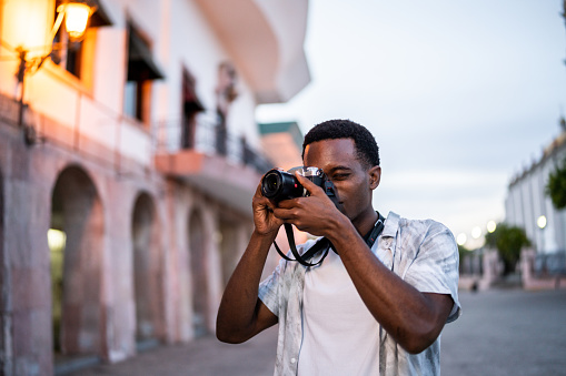 Young man taking pictures at the historic district