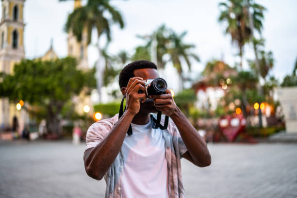 istock Young man taking pictures at the historic district 1483121007